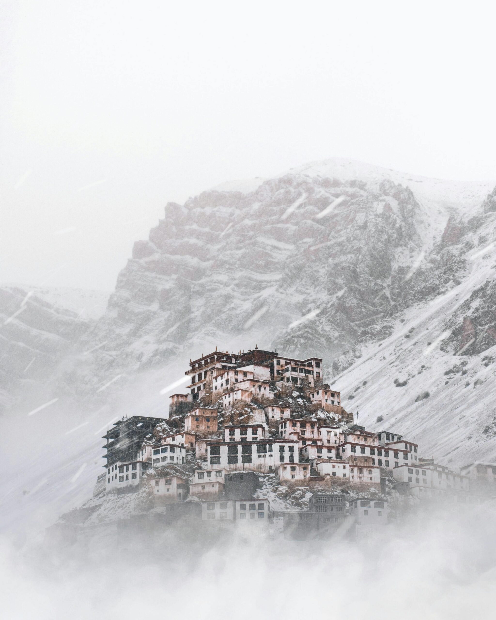 Ancient monastery village nestled in snow-covered Himalayan mountains