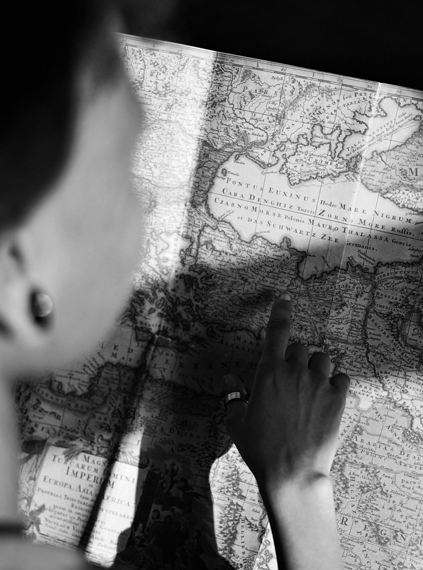 Traveler studying an antique map, planning a unique journey as part of tailored travel packages